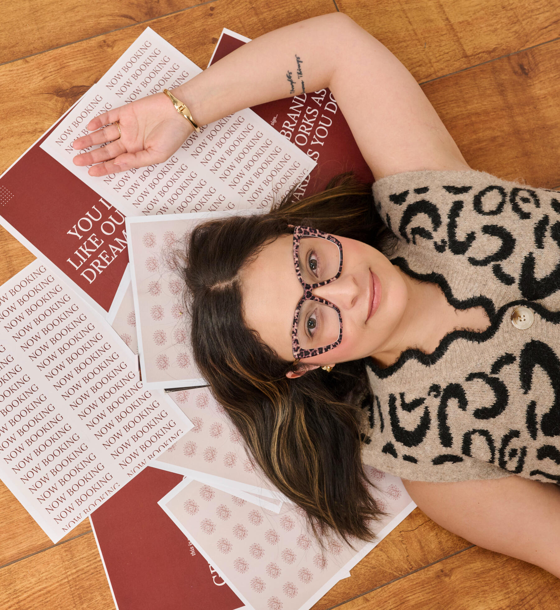 Caulene Flores with branded marketing materials designed by Espinoza Collective